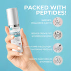 Hand holding a skincare cream bottle with product features on a blue background